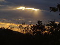 Sluneční paprsky pronikají mraky nad Tišnovem.